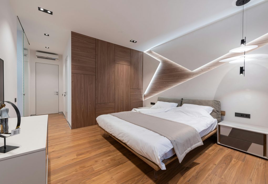 modern hotel room featuring white walls and a wooden accent wall